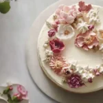 Elegant cake with intricate edible flowers and pastel colors