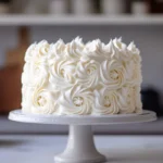 Cloud-shaped cake on a cake stand with pastel decorations